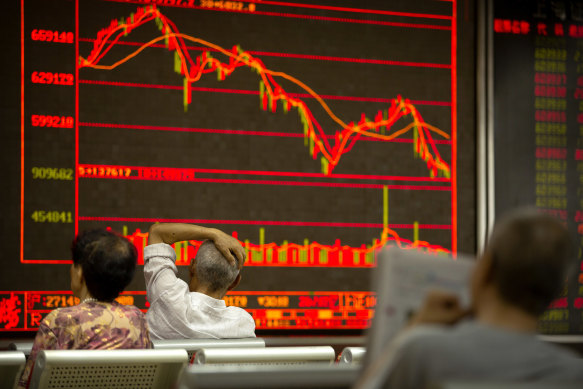 Ups and downs: Monitoring stock at a brokerage house in Beijing.