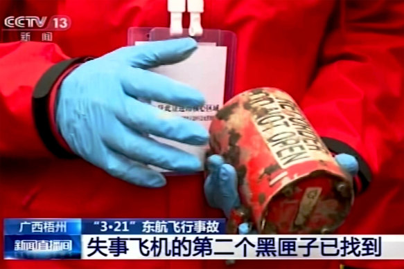 In this image taken from video footage run by China’s CCTV, a search and rescue worker on Sunday holds the second China Eastern “black box” flight recorder. 