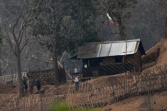 Myanmar soldiers stand at a small army camp along the river bank near the border of Myanmar and Thailand. Ethnic Karen guerillas said they captured the Myanmar army base on Tuesday night.