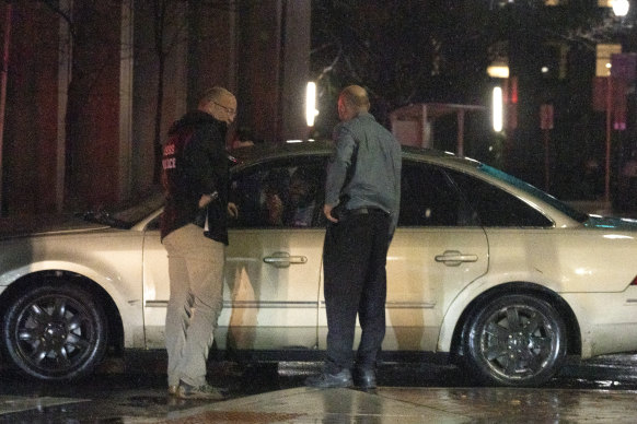 Secret Service Police, left, and security personnel question the driver of a vehicle that ran into a parked SUV that was part of President Biden’s motorcade.