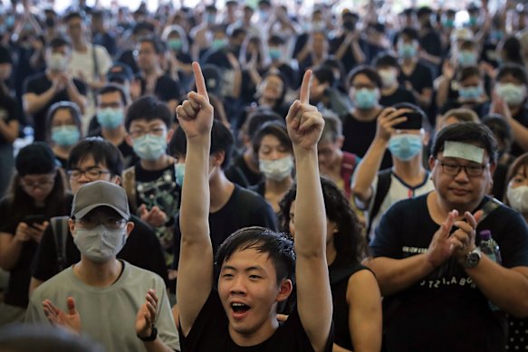 Protesters cheer as they listen to a speech by pro-democracy activist Joshua Wong.