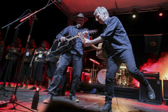 Peter Garrett and Martin Rotsey from Midnight Oil perform at an event to celebrate the closure of the Uluru climb.