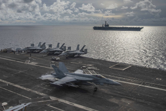 US aircraft carriers the USS Ronald Reagan and the USS Nimitz on patrol in the South China Sea last year. 