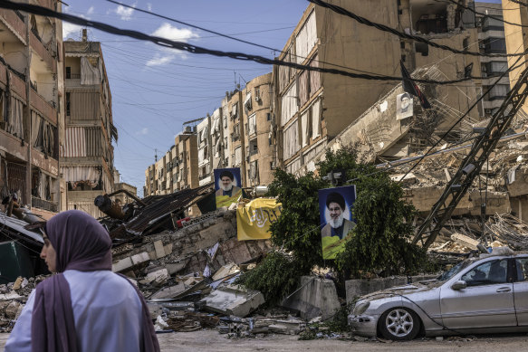 Portraits of slain Hezbollah leader Hassan Nasrallah on a destroyed street in Dahiyeh.