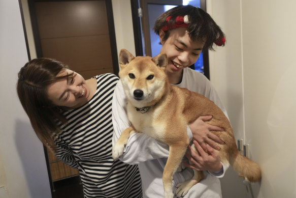 Wataru Yoshida at home with his mother, Kae Yoshida, and their dog, in Tokyo.