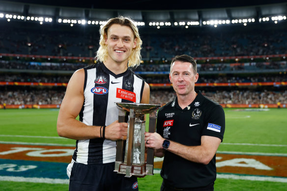 Collingwood captain Darcy Moore and coach Craig McRae with the Anzac Day trophy. 