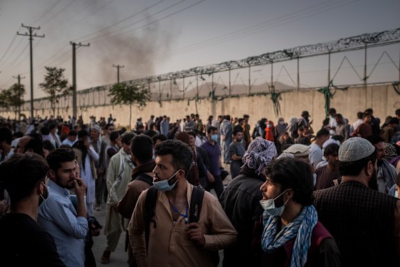 People wait to gain access to the international airport in Kabul, Afghanistan, on August 25, 2021.