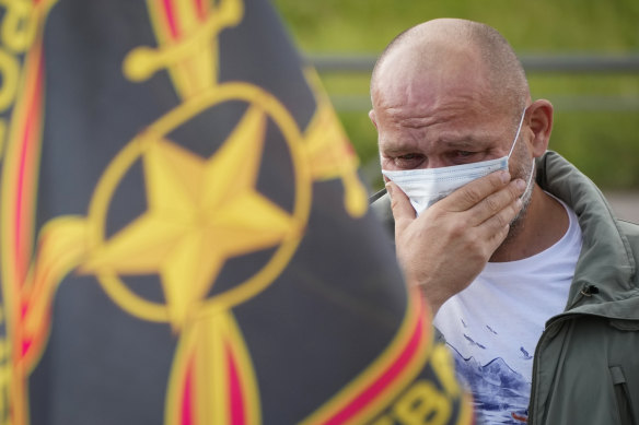 A man cries at a makeshift memorial for Prigozhin in St Petersburg.