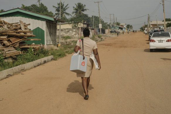 Nurse Deborah Sebi carries immunisations in a refrigerated box on her way to set up a mobile clinic in Teshie, a fishing village near Accra, Ghana.
