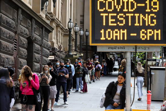 People queue for a COVID-19 test outside the Melbourne Town Hall on Wednesday.