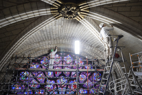 Restorers work on stones around Notre-Dame’s west rose window, which was originally completed in about 1225.