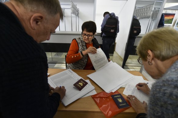 People from Luhansk and Donetsk regions, the territory controlled by a pro-Russia separatist governments, who live in Crimea, get their ballots to vote in a referendum in Sevastopol, Crimea.