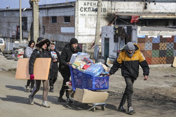 Mariupol residents, who have been without water, get supplies from a warehouse under the control of the government of the self-proclaimed Donetsk People’s Republic. 