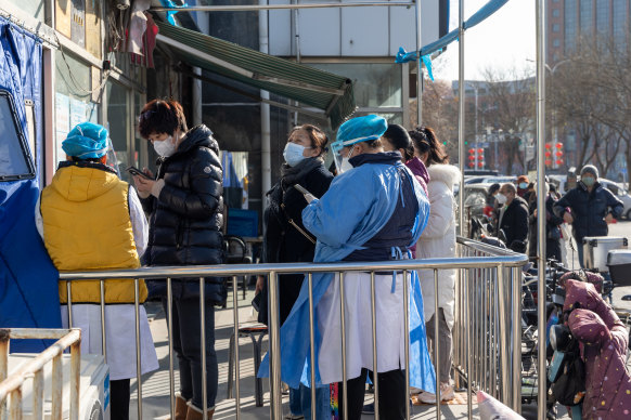 Residents in Beijing wait to get tested for COVID-19 on Thursday. 