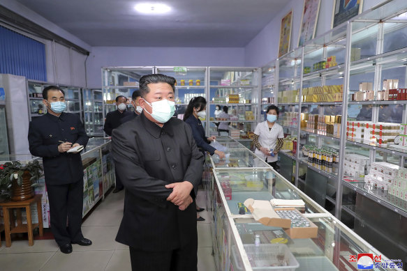 In a photo provided by the North Korean government, North Korean leader Kim Jong Un, center, visits a pharmacy in Pyongyang.
