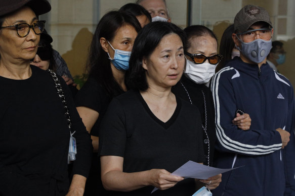 
Stanley Ho's daughter, Pansy (centre), speaks alongside other family members outside a hospital in Hong Kong on Tuesday.