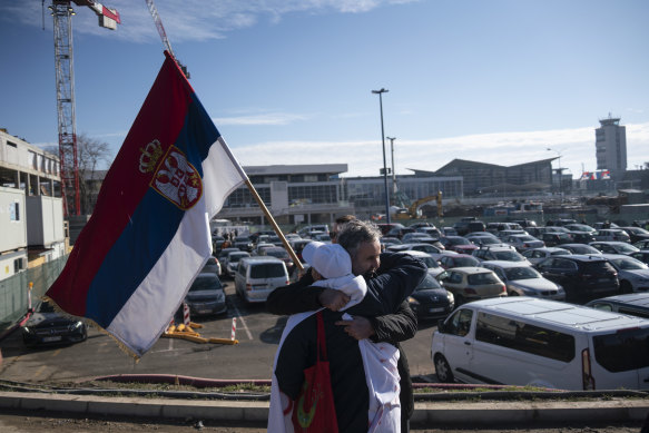 Disappointed Djokovic supporters, carrying Serbian national flags, hug after waiting in vain for him outside the VIP exit of Belgrade’s international airport on January 17.