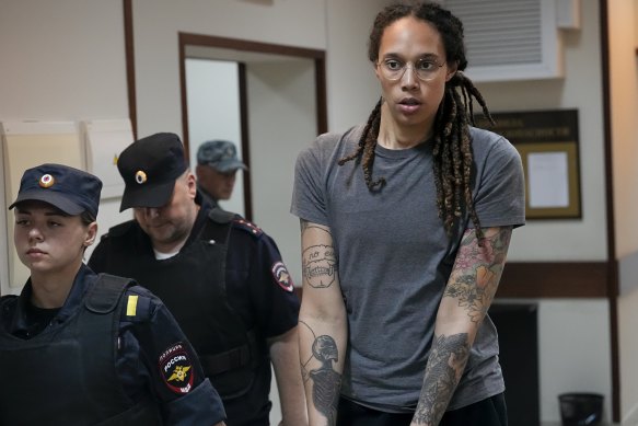 WNBA star and two-time Olympic gold medallist Brittney Griner is escorted from a courtroom.