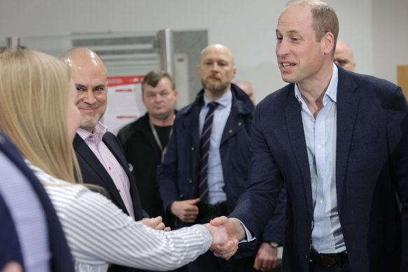 Prince William shakes hands at an accommodation centre during his visit on March 22, 2023 in Warsaw, Poland.