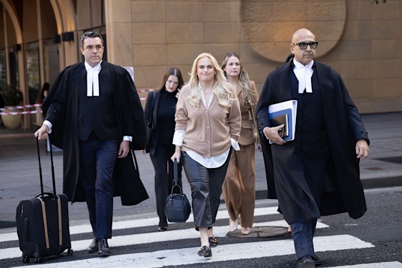Rebel Wilson arrives at the Federal Court in Sydney on Monday with his lawyer Tim Senior, left, and Dauid Sibtain, SC, right.