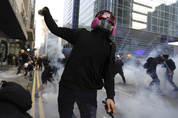 A protester hurls an object as police and demonstrators clash during a protest in Hong Kong on Saturday.