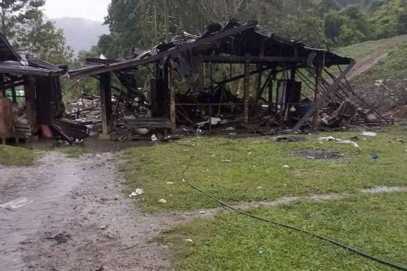 Debris are scattered around destroyed wooden structures near Aung Bar Lay Village, Hpakant township, Kachin state in Myanmar after air strikes by Myanmar’s military that killed scores of people.