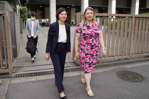 Australian mother Catherine Henderson (right) and her lawyer leave the Tokyo District Court on Thursday. 