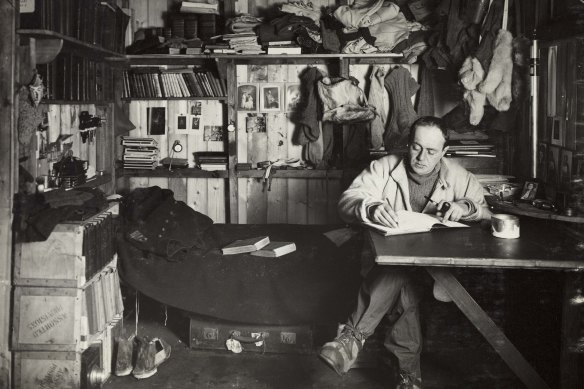 Captain Robert Falcon Scott writing in the expedition hut.