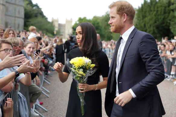 Meghan Duchess of Sussex and Prince Harry, Duke of Sussex speak with well-wishers at Windsor Castle.