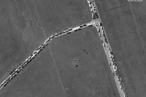 This satellite image provided by Maxar Technologies shows cargo trucks waiting in Kerch, Crimean Peninsula, on Wednesday