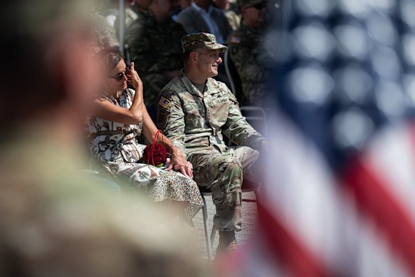 Donahue sits next to his wife during a ceremony honouring him in Wiesbaden in July.