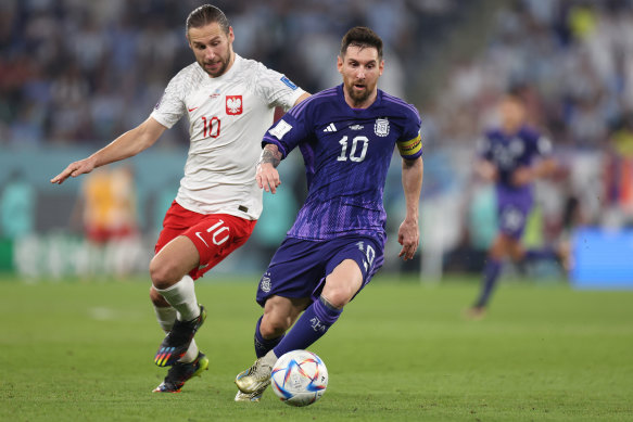 Poland’s Grzegorz Krychowiak keeps a close eye on Messi.