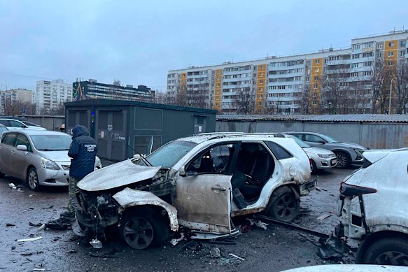 An investigator working at the scene where Lieutenant General Fanil Sarvarov was killed by an explosive device placed under his car in Moscow.