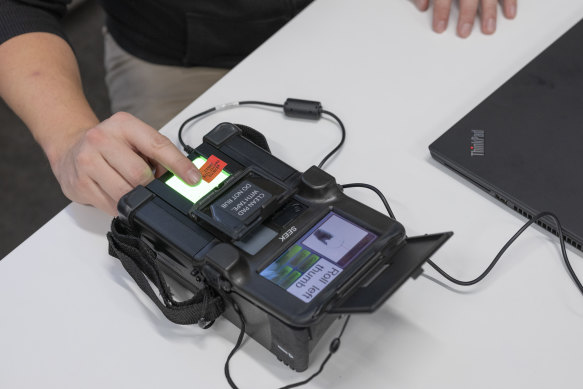 Matthias Marx, a security researcher at the Chaos Computer Club, uses a SEEK II to scan his fingerprint in Hamburg last week.