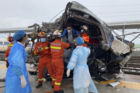 In this photo released by China’s Xinhua News Agency, emergency personnel help a passenger off a damaged train car after it derailed in Rongjiang County in southwestern China’s Guizhou Province, Saturday, June 4, 2022. The driver of a high-speed train in southern China was killed and several people were injured when two cars derailed early Saturday after hitting a mudslide, state broadcaster CCTV reported.