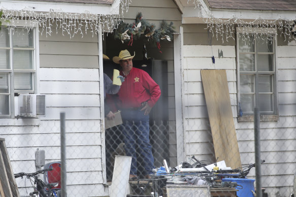 San Jacinto County Sheriff Greg Capers talks to investigators at the scene where five people were shot and killed the night before.