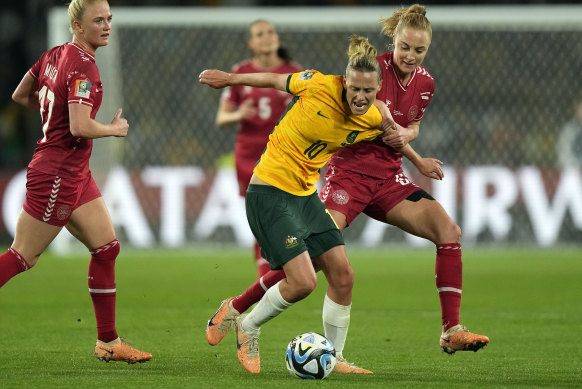 Denmark’s Karen Holmgaard, right, and Australia’s Emily Van Egmond challenge for the ball.