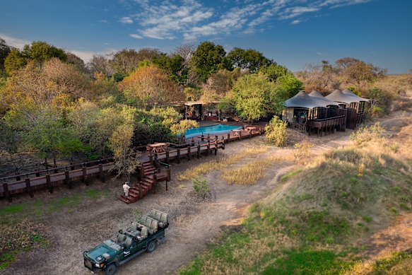 The camp, the pool and the safari LandCruiser.
