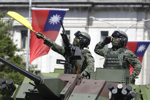 Taiwanese soldiers salute during National Day celebrations in front of the Presidential Office Building in Taipei in October. 