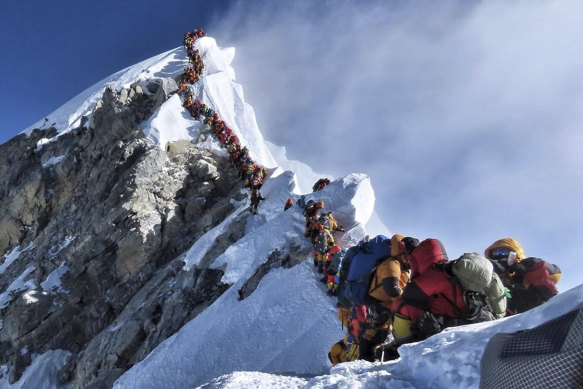 A photo of climbers lining up at the summit of Mount Everest in May 2019.
