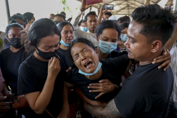 Mourners weeping at the funeral for a protester in Mandalay in February, 2021. Witnesses said the military shot at mourners at a funeral in Yangon on Sunday. 