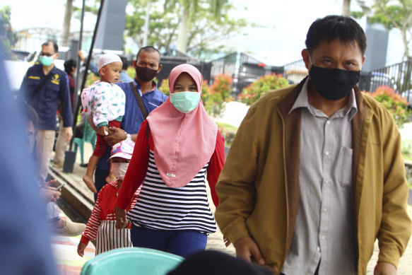 Family members of passengers on Sriwijaya Air SJY-182 arrive to give their relatives' data to the authorities for identification purposes, at Soepadio International Airport in Pontianak, Indonesia.