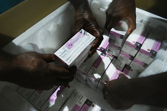 Workers at the Badili medical store in Port Moresby pack the vaccines ready to be sent out to smaller provincial medical stores.