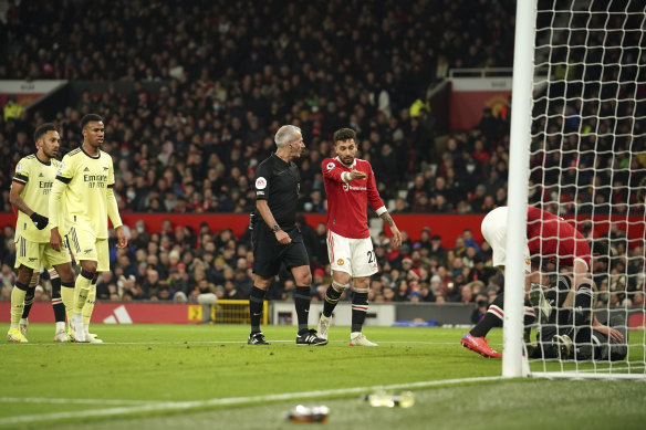 Manchester United’s Alex Telles remonstrates with referee Martin Atkinson after he awarded the controversial goal to Emile Smith Rowe.