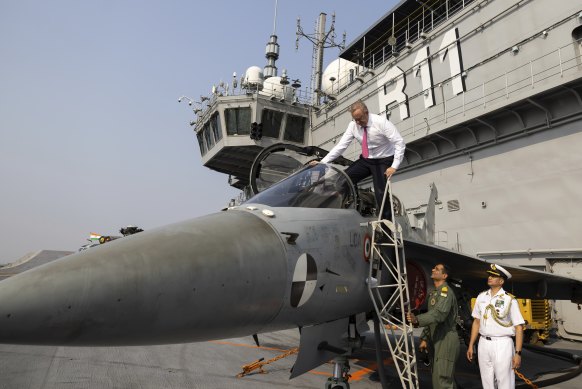 Prime Minister Anthony Albanese climbs into the cockpit of the LCA (light combat aircraft) during a visit to INS Vikrant in Mumbai, India in March 2023.