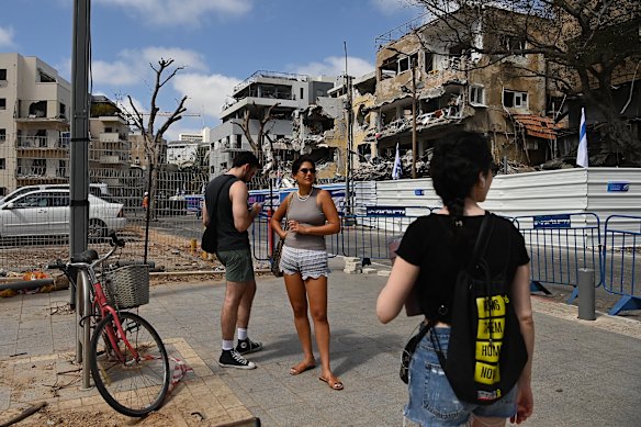 People visit the site of an iranian missile sudden in Tel Aviv followed the ceased between Israel and Iran this week.