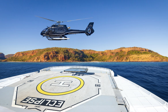 Helicopter leaves the heli-deck aboard Scenic Eclipse II.