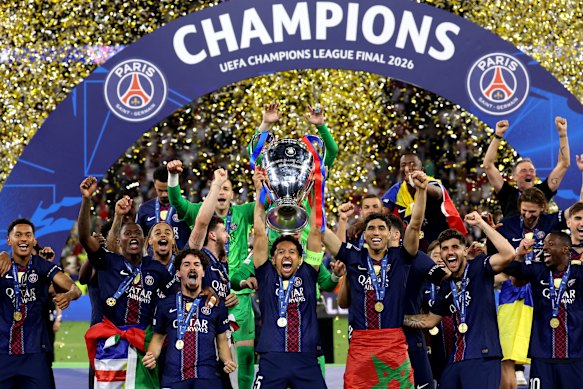 PSG players celebrate with the trophy after winning the Champions League final in Budapest.