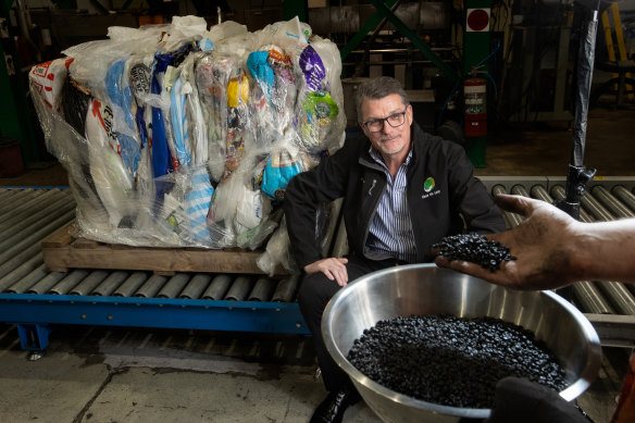 Close the Loop chief executive Joe Foster with a road additive made from recycled soft plastics at the company’s new plant in Reservoir.