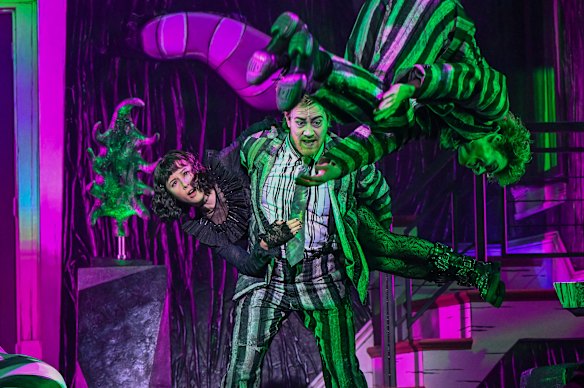 Karis Oka and Eddie Perfect in a scene from Beetlejuice.